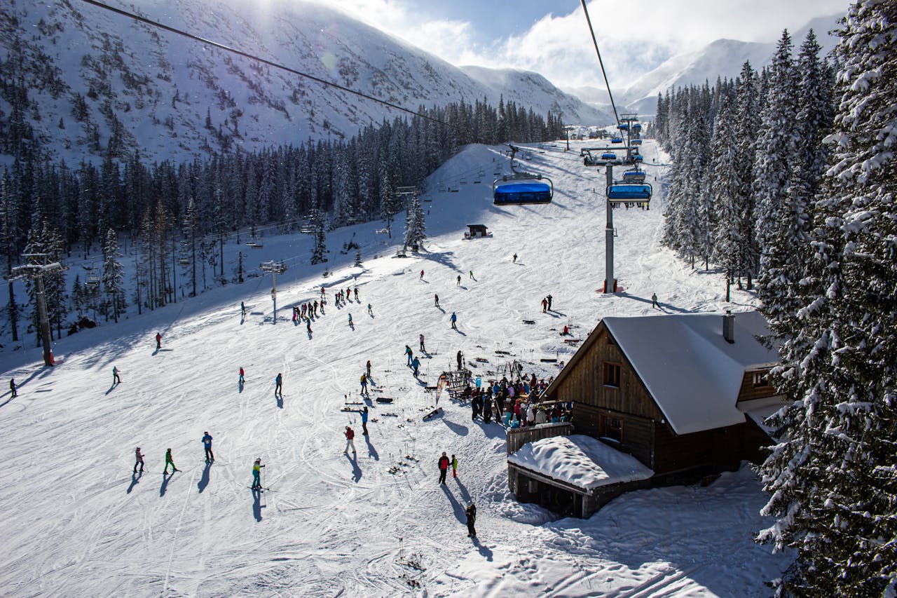 A vibrant ski resort scene in Zuberec, Slovakia, showcasing skiers and snowy slopes.